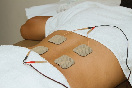 TENS machine for sciatica with pads on a person